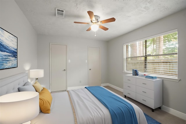 14922 Sandy Creek Dr, Houston, TX 77070 - bedroom featuring baseboards, light carpet, a ceiling fan, and a textured ceiling