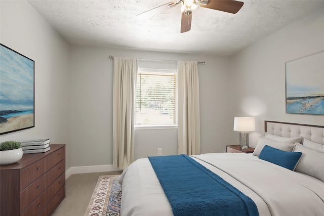 14922 Sandy Creek Dr, Houston, TX 77070 - bedroom featuring a textured ceiling, light carpet, baseboards, and a ceiling fan