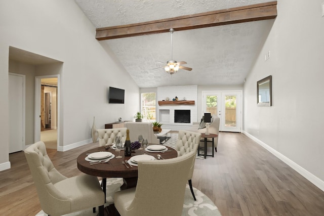 14922 Sandy Creek Dr, Houston, TX 77070 - dining space featuring high vaulted ceiling, plenty of natural light, beam ceiling, baseboards, and wood finished floors