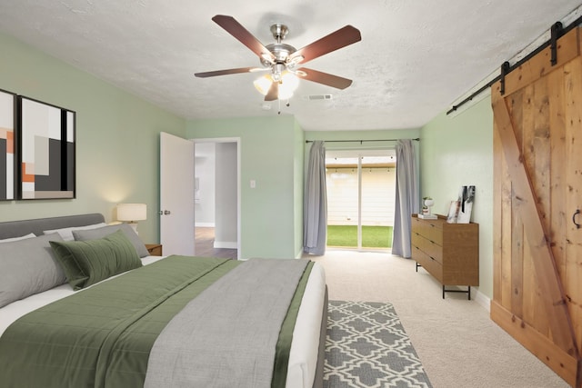 14922 Sandy Creek Dr, Houston, TX 77070 - bedroom featuring access to outside, a barn door, carpet, ceiling fan, and baseboards