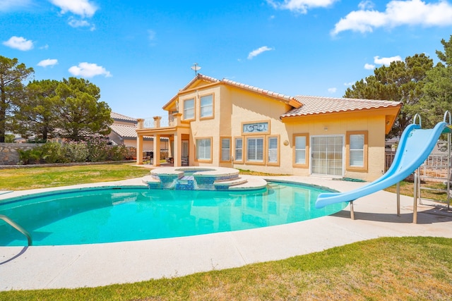 6574 Eagle Ridge Dr, El Paso, TX 79912 - view of pool with a water slide, a patio, a pool with connected hot tub, and a lawn