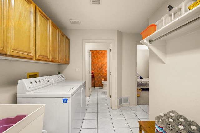 6574 Eagle Ridge Dr, El Paso, TX 79912 - washroom featuring cabinet space, washer and clothes dryer, and light tile patterned floors