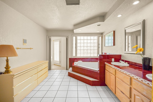 6574 Eagle Ridge Dr, El Paso, TX 79912 - bathroom with a textured ceiling, a jetted tub, vanity, a textured wall, and tile patterned floors