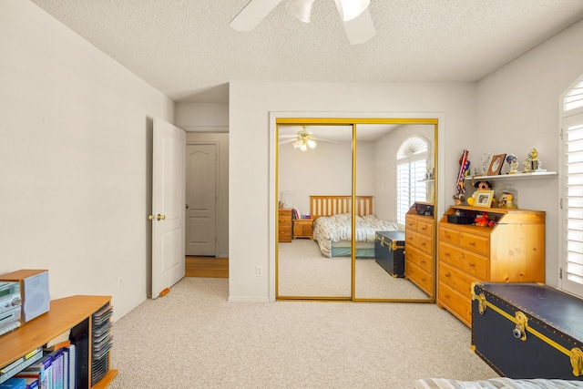6574 Eagle Ridge Dr, El Paso, TX 79912 - bedroom featuring light colored carpet, a closet, a textured ceiling, and ceiling fan