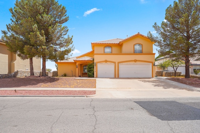 6574 Eagle Ridge Dr, El Paso, TX 79912 - mediterranean / spanish home featuring a tile roof, stucco siding, driveway, and an attached garage