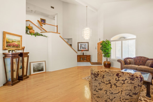 6574 Eagle Ridge Dr, El Paso, TX 79912 - living area with high vaulted ceiling, wood finished floors, stairway, and a chandelier