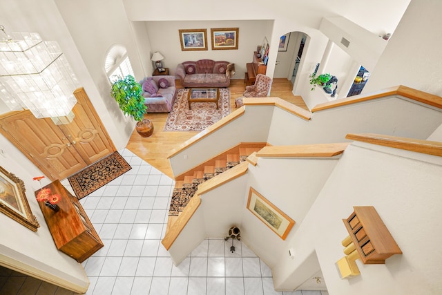 6574 Eagle Ridge Dr, El Paso, TX 79912 - living room with arched walkways, light tile patterned flooring, and a high ceiling