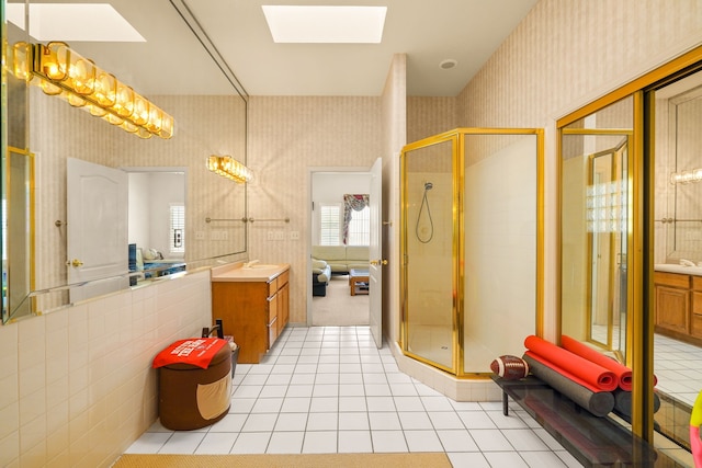 6574 Eagle Ridge Dr, El Paso, TX 79912 - full bathroom with wallpapered walls, a skylight, vanity, and a shower stall