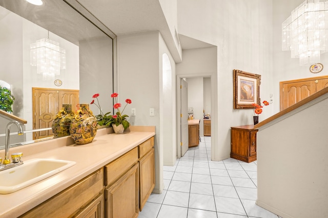 6574 Eagle Ridge Dr, El Paso, TX 79912 - bathroom with a high ceiling, a chandelier, vanity, and tile patterned flooring