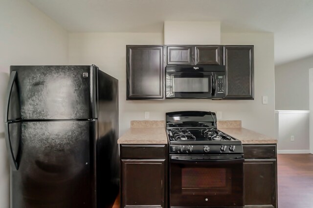 722 Horseshoe Springs Ln, Houston, TX 77090 - kitchen featuring black appliances, light countertops, dark wood-type flooring, and baseboards