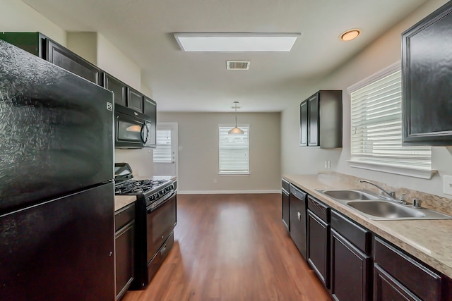 722 Horseshoe Springs Ln, Houston, TX 77090 - kitchen with black appliances, dark wood-style flooring, a sink, light countertops, and decorative light fixtures