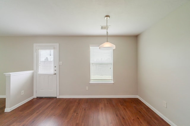 722 Horseshoe Springs Ln, Houston, TX 77090 - unfurnished dining area featuring dark wood-type flooring and baseboards
