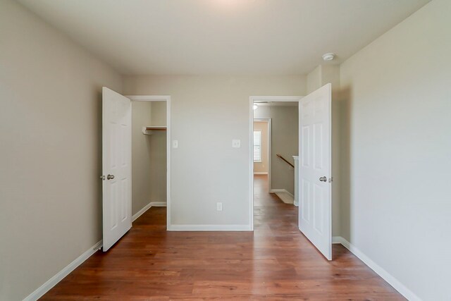 722 Horseshoe Springs Ln, Houston, TX 77090 - unfurnished bedroom with wood finished floors, baseboards, and a spacious closet