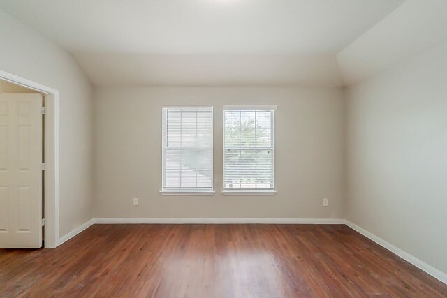 722 Horseshoe Springs Ln, Houston, TX 77090 - spare room featuring lofted ceiling, dark wood finished floors, and baseboards