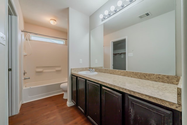 722 Horseshoe Springs Ln, Houston, TX 77090 - bathroom with toilet, vanity, wood finished floors, and shower / tub combination