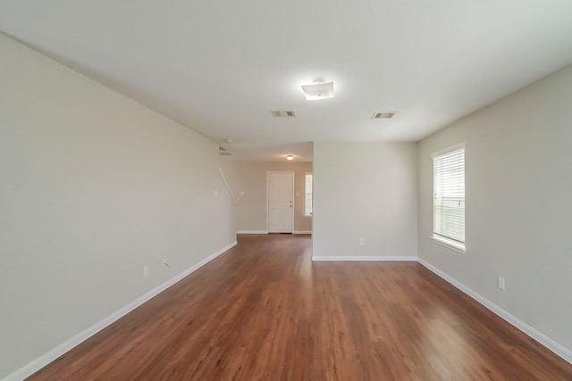 722 Horseshoe Springs Ln, Houston, TX 77090 - spare room featuring dark wood-style flooring, baseboards, and healthy amount of natural light