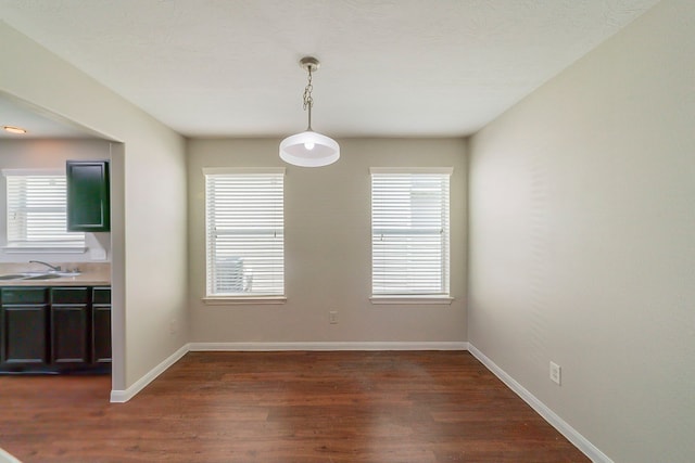 722 Horseshoe Springs Ln, Houston, TX 77090 - unfurnished dining area with dark wood-type flooring, healthy amount of natural light, and a sink