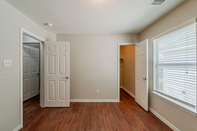 722 Horseshoe Springs Ln, Houston, TX 77090 - unfurnished bedroom featuring a spacious closet, dark wood-type flooring, baseboards, and a closet