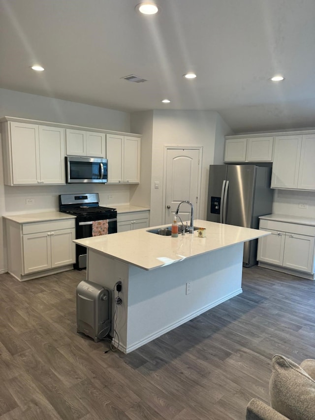 10026 Rose Mallow Ln, Magnolia, TX 77354 - kitchen featuring appliances with stainless steel finishes, a sink, dark wood-type flooring, white cabinetry, and recessed lighting