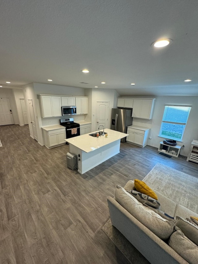 10026 Rose Mallow Ln, Magnolia, TX 77354 - living room featuring dark wood-type flooring and recessed lighting