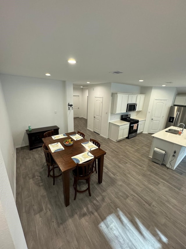 10026 Rose Mallow Ln, Magnolia, TX 77354 - dining area with dark wood-type flooring and recessed lighting
