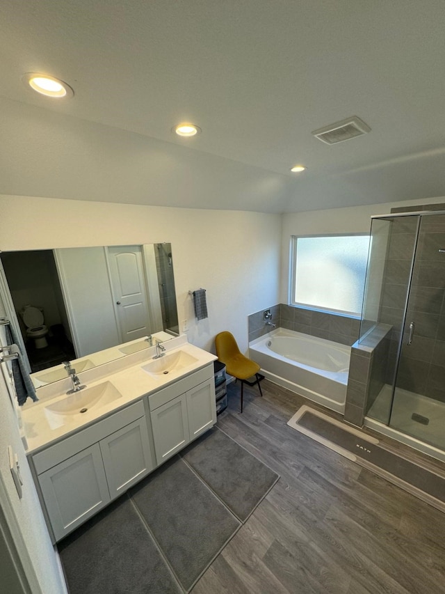 10026 Rose Mallow Ln, Magnolia, TX 77354 - bathroom with a garden tub, wood finished floors, a shower stall, double vanity, and toilet