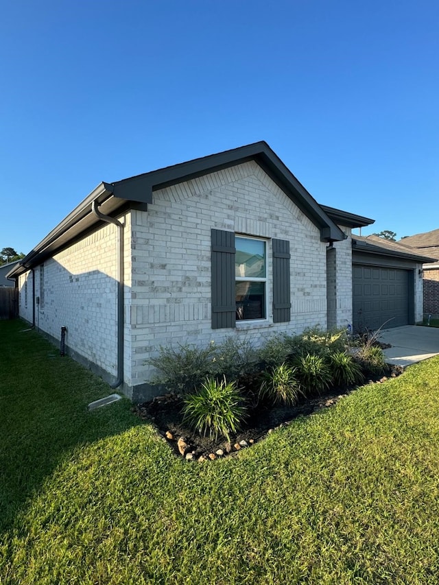 10026 Rose Mallow Ln, Magnolia, TX 77354 - view of property exterior with brick siding, a yard, an attached garage, and driveway
