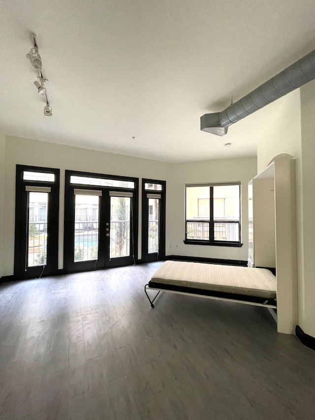 1901 Post Oak Blvd Unit 1213, Houston, TX 77056 - entryway featuring wood finished floors, track lighting, healthy amount of natural light, and baseboards