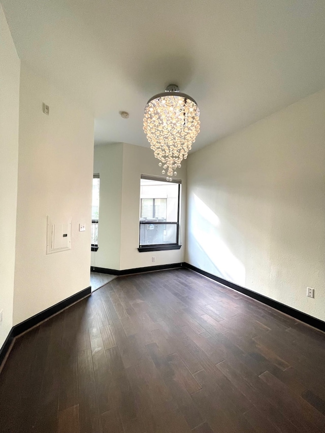 1901 Post Oak Blvd Unit 1213, Houston, TX 77056 - unfurnished room with a chandelier, wood finished floors, and baseboards