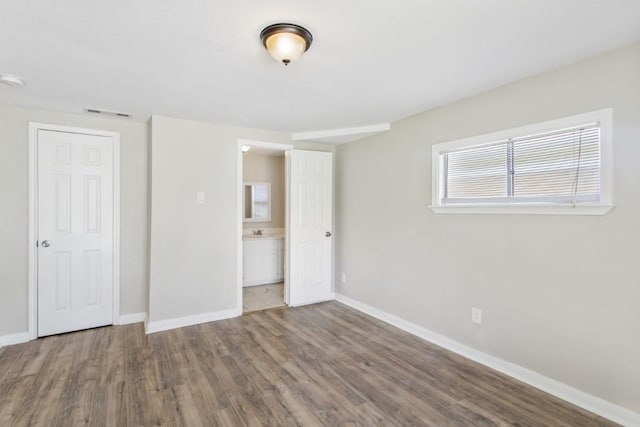 208 Preston St, La Marque, TX 77568 - unfurnished bedroom featuring baseboards and wood finished floors