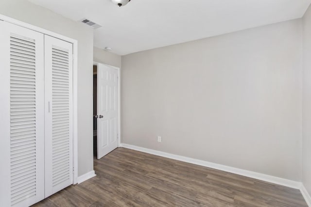 208 Preston St, La Marque, TX 77568 - unfurnished bedroom featuring baseboards, wood finished floors, and a closet