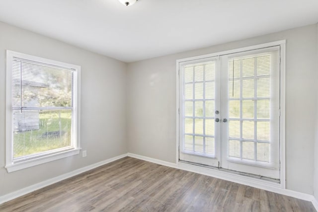 208 Preston St, La Marque, TX 77568 - empty room featuring baseboards, wood finished floors, and french doors