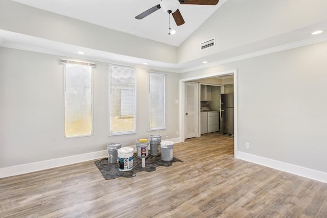 208 Preston St, La Marque, TX 77568 - unfurnished living room with ceiling fan, washing machine and dryer, lofted ceiling, recessed lighting, and wood finished floors