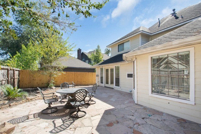 17902 Fernbluff Dr, Spring, TX 77379 - fenced backyard featuring a patio and outdoor dining space