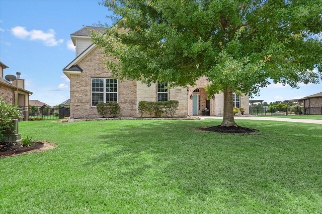 231 N Waterstone Dr, Montgomery, TX 77356 - view of property hidden behind natural elements featuring brick siding