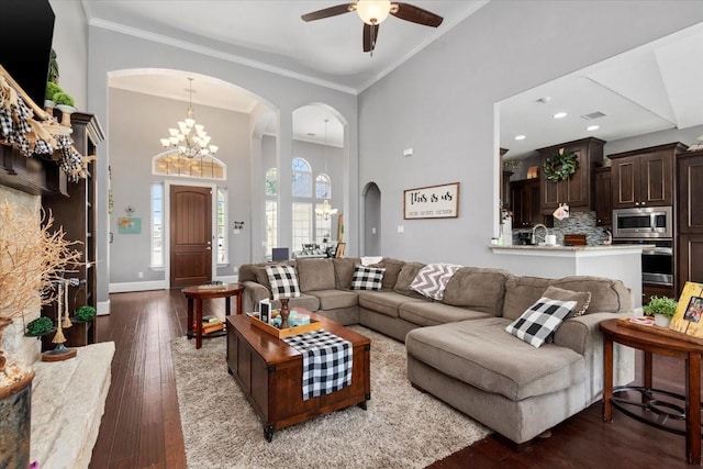 231 N Waterstone Dr, Montgomery, TX 77356 - living room with arched walkways, a chandelier, wood-type flooring, ceiling fan, and crown molding