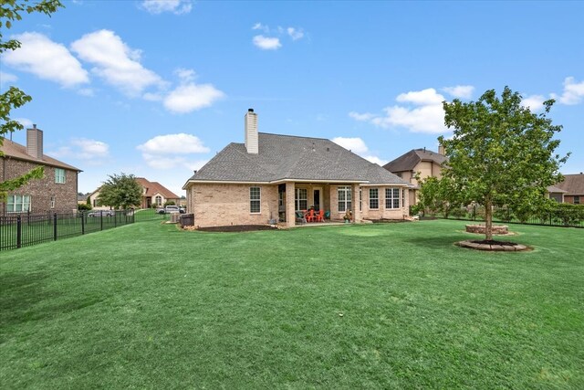 231 N Waterstone Dr, Montgomery, TX 77356 - back of house featuring brick siding, a chimney, and a patio
