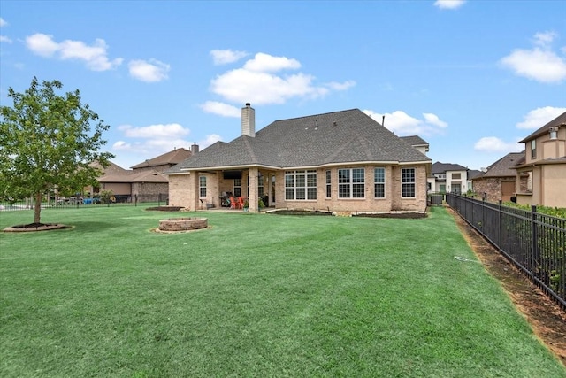 231 N Waterstone Dr, Montgomery, TX 77356 - back of house featuring a chimney, brick siding, and a fire pit