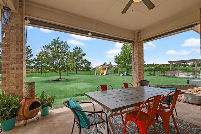 231 N Waterstone Dr, Montgomery, TX 77356 - view of patio featuring outdoor dining space, a ceiling fan, and a playground