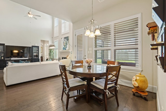 9810 Mount Whitney, Missouri City, TX 77459 - dining room featuring a chandelier, hardwood / wood-style flooring, a ceiling fan, a fireplace, and a towering ceiling