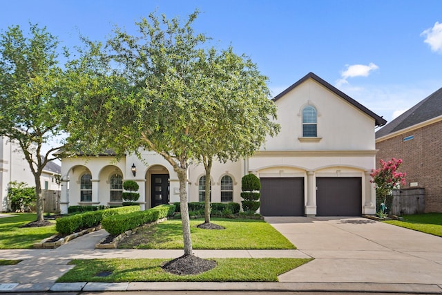 9810 Mount Whitney, Missouri City, TX 77459 - view of front facade with stucco siding, a front yard, a garage, and driveway
