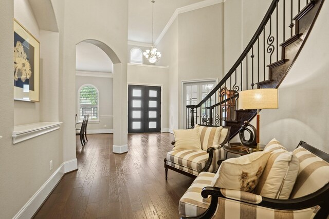 9810 Mount Whitney, Missouri City, TX 77459 - entryway with baseboards, ornamental molding, dark wood finished floors, a towering ceiling, and a chandelier