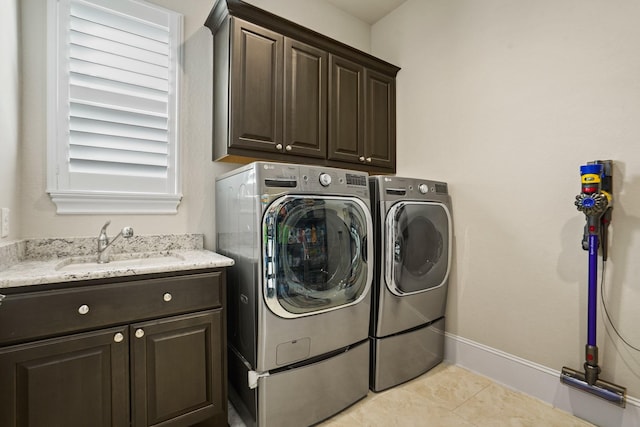 9810 Mount Whitney, Missouri City, TX 77459 - laundry area featuring cabinet space, washing machine and clothes dryer, light tile patterned flooring, and baseboards