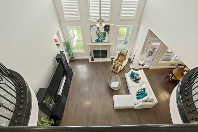 9810 Mount Whitney, Missouri City, TX 77459 - living area featuring a towering ceiling, healthy amount of natural light, a glass covered fireplace, and wood finished floors