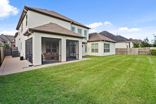 9810 Mount Whitney, Missouri City, TX 77459 - back of property with a sunroom, central AC, stucco siding, a shingled roof, and a patio