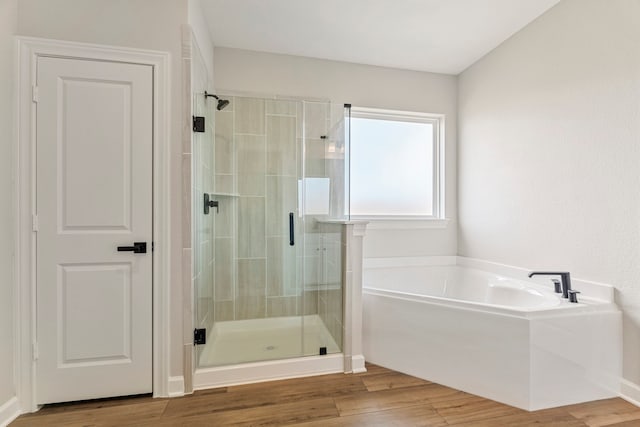 10518 Sutter Creek Dr, Iowa Colony, TX 77583 - full bathroom featuring a shower stall, a garden tub, and wood finished floors