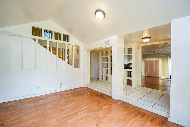 8602 Ariel St, Houston, TX 77074 - empty room with wood finished floors and vaulted ceiling