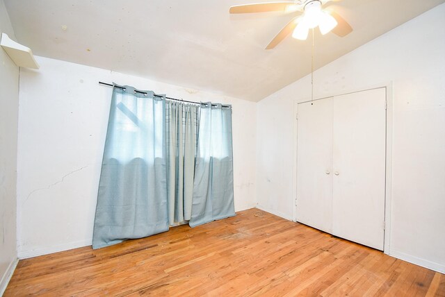 8602 Ariel St, Houston, TX 77074 - unfurnished bedroom featuring wood finished floors, vaulted ceiling, a closet, and ceiling fan