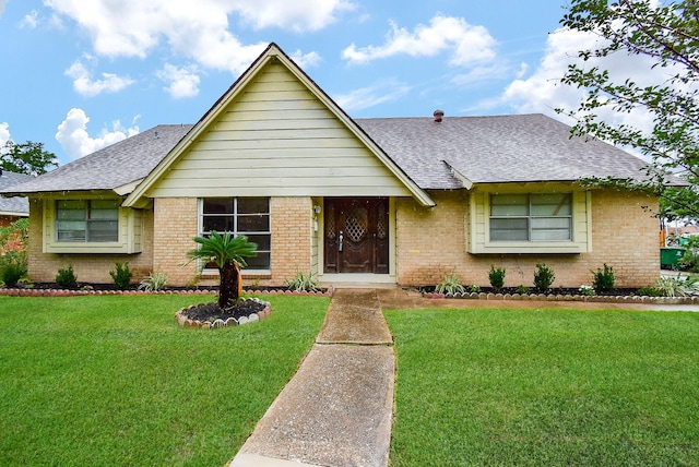 8602 Ariel St, Houston, TX 77074 - view of front of house with roof with shingles, brick siding, and a front lawn
