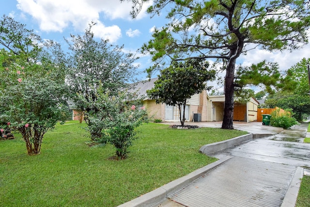 8602 Ariel St, Houston, TX 77074 - view of property hidden behind natural elements with a front lawn, central air condition unit, and brick siding